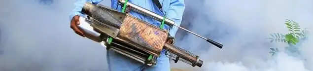 Fumigation technician using a fogger for deep pest treatment in Akron, OH